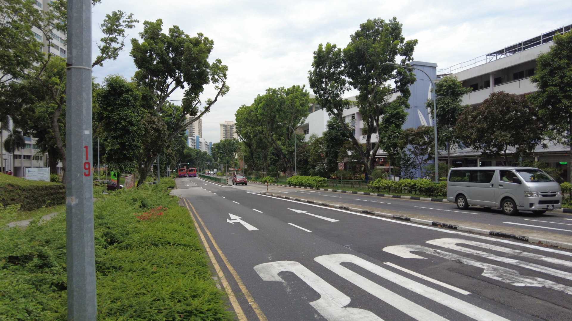 View of Bedok North St 1, a street near Bedok Town Centre and Heartbeat@Bedok. Despite being a silver zone, the carriageway is still fairly wide with 4 lanes of vehicular traffic. Photograph taken by me. CC-BY-SA 4.0